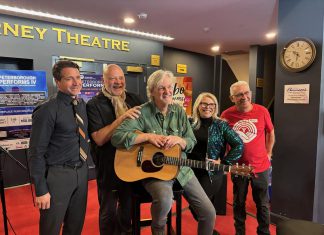 Joe Grant of LLF Lawyers, United Way Peterborough & District executive director Jim Russell, performer musician Mark Beatty, main stage emcee Ella Bates, and event co-founder and organizer Paul Rellinger during a media event at Showplace Performance Centre on February 12, 2026 to promote the Peterborough Performs VI: Musicians United To End Homelessness benefit concert on Thursday, February 26. (Photo: Adeline Murphy / United Way)