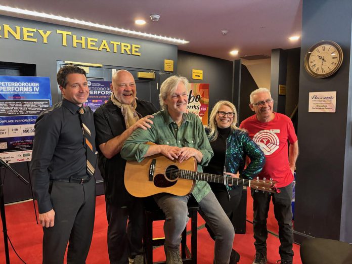 Joe Grant of LLF Lawyers, United Way Peterborough & District executive director Jim Russell, performer musician Mark Beatty, main stage emcee Ella Bates, and event co-founder and organizer Paul Rellinger during a media event at Showplace Performance Centre on February 12, 2026 to promote the Peterborough Performs VI: Musicians United To End Homelessness benefit concert on Thursday, February 26. (Photo: Adeline Murphy / United Way)