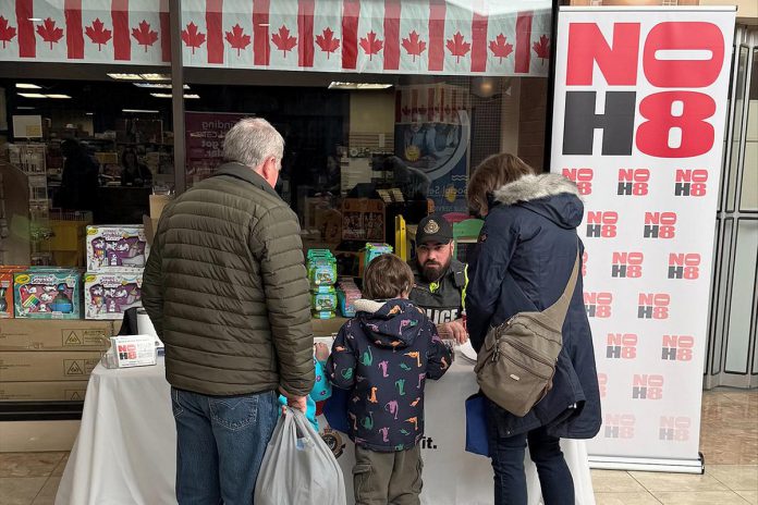 A member of the Peterborough Police Service at a booth during Family Literacy Day at Peterborough Square on January 24, 2026 sharing information with the community about the refreshed N0H8 ("No Hate") public education and awareness campaign. The campaign aims to bring awareness to hate and bias incidents and to provide resources on how such incidents can be reported. (Photo: Peterborough Police Service)
