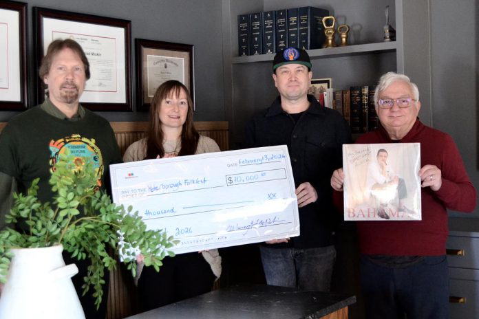 Murray Miskin of Miskin Law (holding the latest record by Bahamas) presenting a $10,000 cheque to (from left) Peterborough Folk Festival chair Rob Davis, secretary Rebecca Schillemat, and artistic director Ryan Kemp. (Photo courtesy of Peterborough Folk Festival)