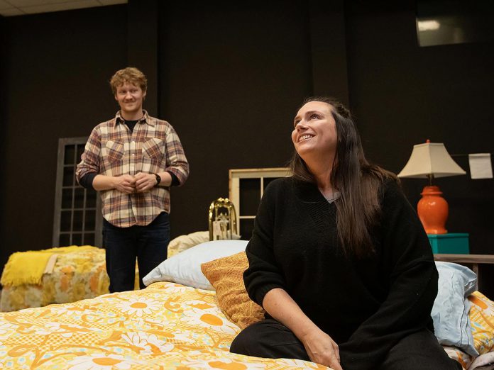 Eddy Sweeney as Wesley and Carling Dulder as Anna during a rehearsal of the Peterborough Theatre Guild's production of "Midnight Madness" by award-winning Peterborough-born playwright Dave Carley. Directed by Jane Werger, the heartfelt comedy runs for 10 performances from February 27 to March 14, 2026. (Photo: Jordan Lyall Photography)