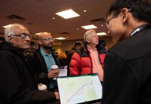 An Alto team member, with a tablet showing the corridor options between Ottawa and Toronto for the high-speed rail network, speaks with attendees during an open house held at the McDonnel Street Activity Centre in Peterborough on February 26, 2026. Peterborough is one of seven stops on the proposed network. (Photo: Jordan Lyall / kawarthaNOW)