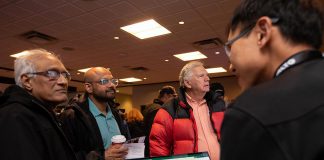 An Alto team member, with a tablet showing the corridor options between Ottawa and Toronto for the high-speed rail network, speaks with attendees during an open house held at the McDonnel Street Activity Centre in Peterborough on February 26, 2026. Peterborough is one of seven stops on the proposed network. (Photo: Jordan Lyall / kawarthaNOW)