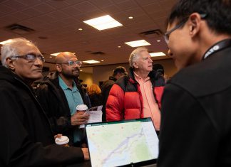 An Alto team member, with a tablet showing the corridor options between Ottawa and Toronto for the high-speed rail network, speaks with attendees during an open house held at the McDonnel Street Activity Centre in Peterborough on February 26, 2026. Peterborough is one of seven stops on the proposed network. (Photo: Jordan Lyall / kawarthaNOW)