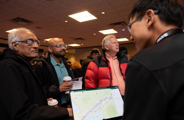 An Alto team member, with a tablet showing the corridor options between Ottawa and Toronto for the high-speed rail network, speaks with attendees during an open house held at the McDonnel Street Activity Centre in Peterborough on February 26, 2026. Peterborough is one of seven stops on the proposed network. (Photo: Jordan Lyall / kawarthaNOW)