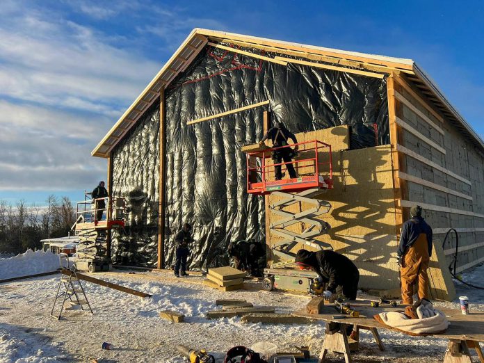 When faced with permitting issues, 100 Acres Brewing Co. of Peterborough was left with a timber frame building with no roof or walls just as winter weather grew more severe. Bullarco Roofing & Full Exteriors came to the rescue to install a metal roof and siding just before Christmas. (Photo courtesy of Bullarco Roofing & Full Exteriors)