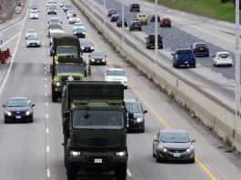 Canadian Armed Forces vehicles travelling on a highway. (Photo: Department of National Defence, Canadian Armed Forces)
