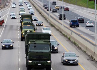 Canadian Armed Forces vehicles travelling on a highway. (Photo: Department of National Defence, Canadian Armed Forces)