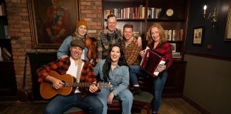The cast of the Capitol Theatre's production of the Broadway smash-hit musical "Come From Away," which runs from July 10 to August 2, 2026 at the historic venue in Port Hope, includes (front) Beau Dixon and Julie Lumsden and (back) Melissa Payne, Kyle Blair, Kyle Golemba, and Donna Garner. (Photo: Sam Moffatt)