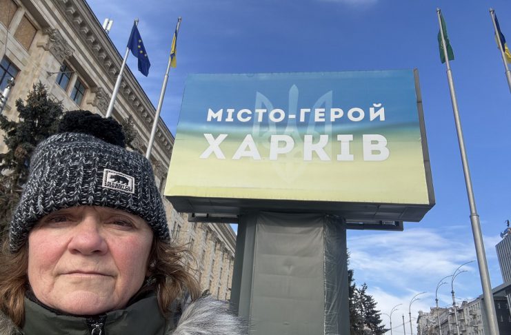 Peterborough native Chloë Black in front of a sign that reads "Hero City Kharkiv" during her sixth trip to Ukraine since Russia launched its full-scale invasion in 2022. Black is currently in Kharkiv volunteering with a local animal shelter and will soon be returning to Kyiv to support the Ukrainian Patriot organization in helping children who have been impacted by the war. (Photo: Chloë Black)