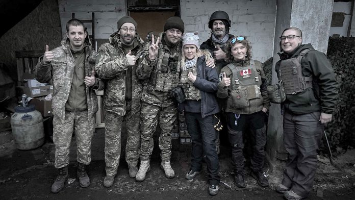 Peterborough native Chloë Black with frontline defenders in Ukraine while on a humanitarian aid mission. Though she has no military background, Black always held a deep appreciation for and respect for people who serve for their country. She felt inspired to begin her volunteer efforts after Russia's first attacks in Ukraine in 2022 when the world wasn't quickly responding in the way she thought they would. (Photo courtesy of Chloë Black)