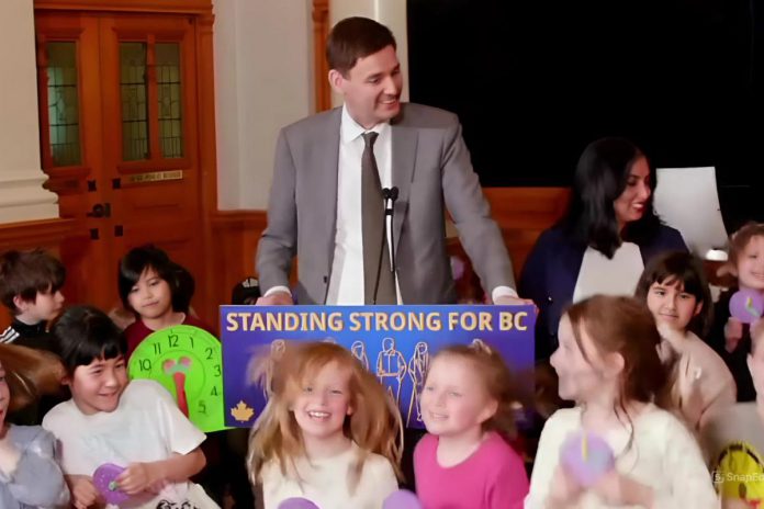 Surrounded by school children, British Columbia premier David Ebey announced on March 2, 2026 that the province would change its clocks for the final time, permanently adopting daylight saving time. (kawarthaNOW screenshot)