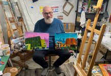 Peterborough artist David Geene explores the ethics and politics of proposed high rises in ‘Economies of Scale?’ exhibit Artist David Geene in his home studio with two 12 by 16 inch paintings of existing buildings that will be featured in his "Economies of Scale?" solo exhibit at Watson & Lou in downtown Peterborough from April 4 to 25, 2026. Titled (left to right) "196 Hunter Street East" and "212 Brock Street from Hunter W. and Aylmer Streets," the works are two of the 12 acrylic paintings that aim to explore the politics and ethics of two proposed high-rise structures in Peterborough, at 90 Hunter Street and on Crescent Street. Including interpretations of the proposed buildings, the exhibit will launch with an opening reception from 2 to 4 p.m. on Saturday, April 4. (Photo courtesy of David Geene)