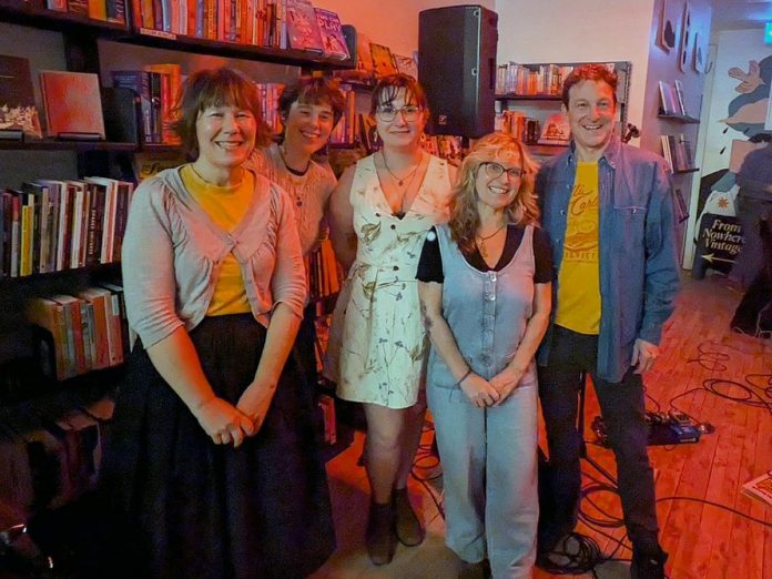 New authors published by Give a Sheet Press (Jessica Westhead, Kayleigh Mochan, Avery Brown, and Erica Richmond) stand with Give a Sheet Press founder Chris Magwood. Take Cover Books celebrated the launch of volume two of the revitalized "little book" press during the Highly Likely Festival of Music and Literature on February 28, 2026. (Photo courtesy of Erica Richmond)