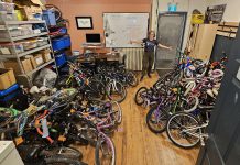 B!KE program manager Jean Greig with kids' bikes in need of refurbishing. Through the Kids Bike Build program, B!KE volunteers repair donated bikes and provide them to partner organizations who distribute them to children and families who may not otherwise have the means to obtain one. (Photo courtesy of B!KE)