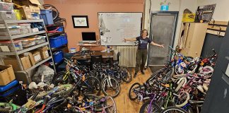 B!KE program manager Jean Greig with kids' bikes in need of refurbishing. Through the Kids Bike Build program, B!KE volunteers repair donated bikes and provide them to partner organizations who distribute them to children and families who may not otherwise have the means to obtain one. (Photo courtesy of B!KE)