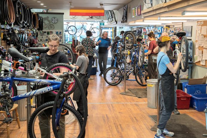 B!KE staff and volunteers refurbishing kids' bikes during Kids Bike Build day on April 13, 2025 at the community bike shop's location in downtown Peterborough. (Photo: Luke Best)