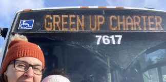 GreenUP education program coordinator Melanie Ellison and education and active transportation program manager Ashley Burnie Seeds in front of the Peterborough Transit bus that served as a classroom for Grade 7 and 8 students from St. Paul Catholic Elementary School in Lakefield on February 12, 2026. The students experienced hands-on education to familiarize them with riding transit safely and with confidence. (Photo: Melanie Ellison / GreenUP)