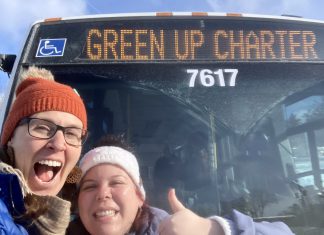 GreenUP education program coordinator Melanie Ellison and education and active transportation program manager Ashley Burnie Seeds in front of the Peterborough Transit bus that served as a classroom for Grade 7 and 8 students from St. Paul Catholic Elementary School in Lakefield on February 12, 2026. The students experienced hands-on education to familiarize them with riding transit safely and with confidence. (Photo: Melanie Ellison / GreenUP)