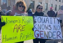 Participants of the 2025 International Women's Day rally outside Peterborough City Hall organized by Kawartha Sexual Assault Centre (KSAC) and Kawartha World Issues Centre (KWIC) and supported by the Peterborough Public Library. The YWCA Peterborough Haliburton is also partnering with the organizations for the 2026 event on Saturday, March 7, which includes a rally and march to a community event at the library featuring music, food, a keynote, and conversations. The event aligns with this year's United Nations' International Women's Day 2026 theme of "Rights. Justice. Action. For ALL Women and Girls." (Photo courtesy of KSAC/KWIC)