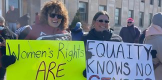Participants of the 2025 International Women's Day rally outside Peterborough City Hall organized by Kawartha Sexual Assault Centre (KSAC) and Kawartha World Issues Centre (KWIC) and supported by the Peterborough Public Library. The YWCA Peterborough Haliburton is also partnering with the organizations for the 2026 event on Saturday, March 7, which includes a rally and march to a community event at the library featuring music, food, a keynote, and conversations. The event aligns with this year's United Nations' International Women's Day 2026 theme of "Rights. Justice. Action. For ALL Women and Girls." (Photo courtesy of KSAC/KWIC)
