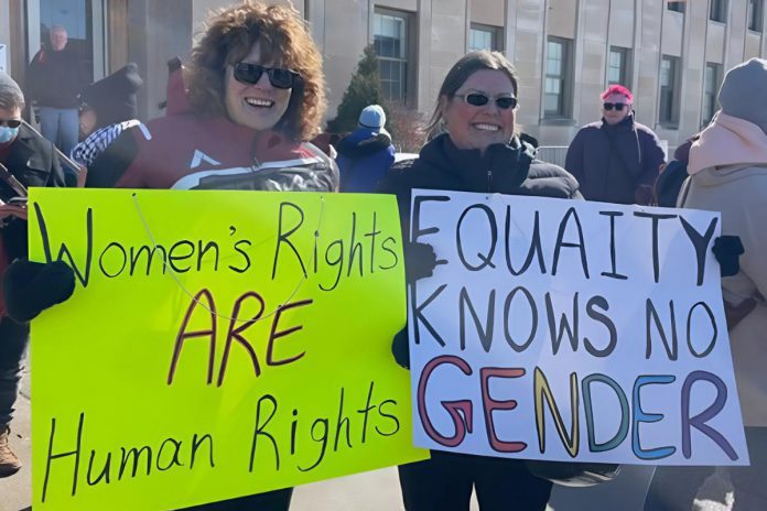 Participants of the 2025 International Women's Day rally outside Peterborough City Hall organized by Kawartha Sexual Assault Centre (KSAC) and Kawartha World Issues Centre (KWIC) and supported by the Peterborough Public Library. The YWCA Peterborough Haliburton is also partnering with the organizations for the 2026 event on Saturday, March 7, which includes a rally and march to a community event at the library featuring music, food, a keynote, and conversations. The event aligns with this year's United Nations' International Women's Day 2026 theme of "Rights. Justice. Action. For ALL Women and Girls." (Photo courtesy of KSAC/KWIC)