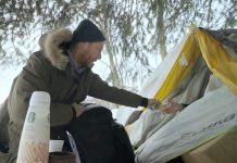 Chris Vyn, former outreach worker with One City Peterborough, provides food and supplies to a woman experiencing homelessness in 2022. (kawarthaNOW screenshot of One City Peterborough video)