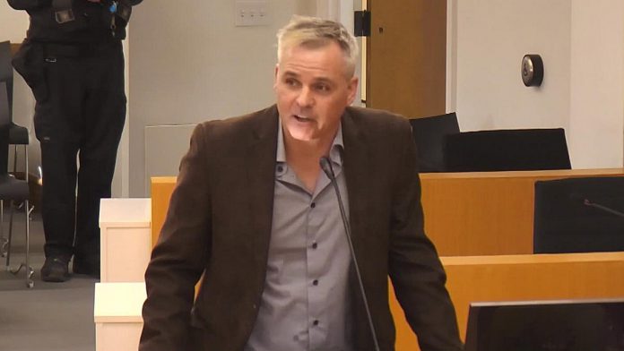 Runner's Life owner Dave Dame, who organizes the St. Patrick's Day 5k Run and Walk, addressing Peterborough city council on March 9, 2026 about the last-minute decision of city staff to deny a permit for the annual fundraising event. (kawarthaNOW screenshot of City of Peterborough video)