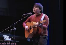 Tristan Konkle performs his song "Killing Time" at the Peterborough Folk Festival's Emerging Artist Award announcement at Market Hall Performing Arts Centre in downtown Peterborough on March 12, 2026. As the winner of the 2026 award, Konkle will be given showcase performance spots at the Peterborough Folk Festival in August and will receive a trip to the Folk Music Ontario Conference, the $1,000 PMBA Lynn Morris Memorial Award, and recording and production of a single courtesy of Electric Alchemy Recording Studio. (Photo: Luke Best)
