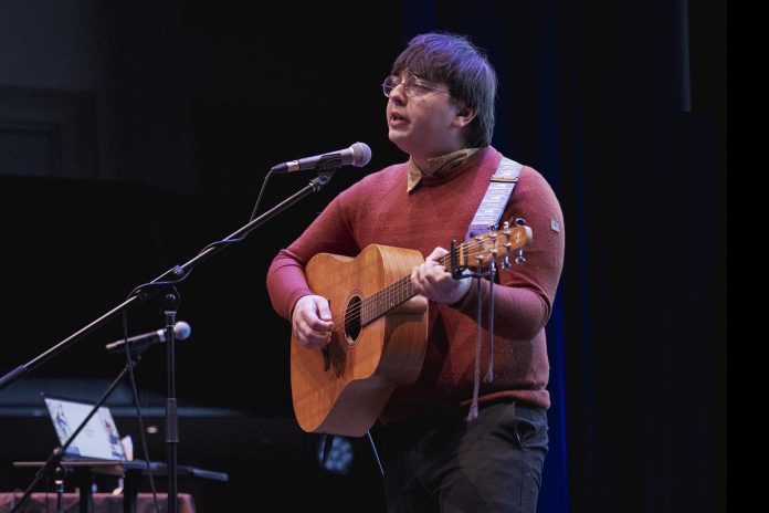 Tristan Konkle performs his song "Killing Time" at the Peterborough Folk Festival's Emerging Artist Award announcement at Market Hall Performing Arts Centre in downtown Peterborough on March 12, 2026. As the winner of the 2026 award, Konkle will be given showcase performance spots at the Peterborough Folk Festival in August and will receive a trip to the Folk Music Ontario Conference, the $1,000 PMBA Lynn Morris Memorial Award, and recording and production of a single courtesy of Electric Alchemy Recording Studio. (Photo: Luke Best)