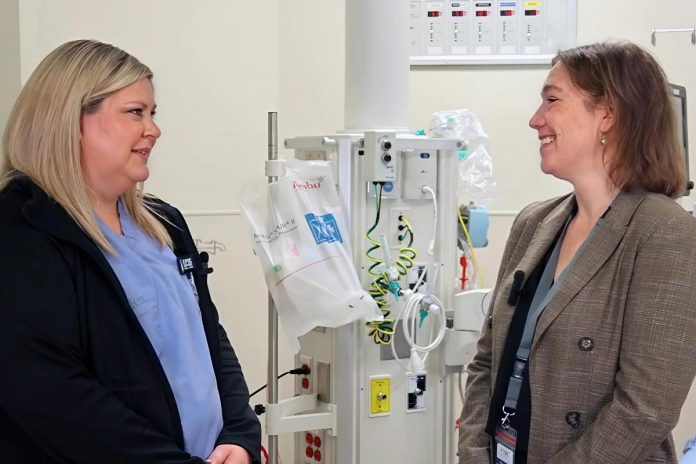 Peterborough Regional Health Centre (PRHC) president and CEO Dr. Lynn Mikula (right) speaking with the Emergency Department Unit Clerk at the regional hospital. Dr. Mikula supports breaking down barriers for women in healthcare, especially in leadership positions since they are not often filled by women despite the workforce being largely female. (Photo courtesy of PRHC)