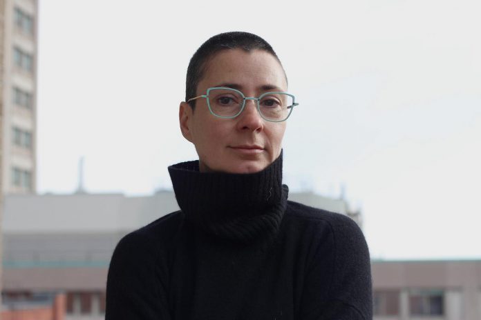 Based in Ottawa, Laura Taler is a Romanian-born Canadian artist who works across a range of media including performance, film, sound, sculpture, and installation. Praised for its unique combination of emotional resonance, wit, and striking visuals, her acclaimed work has been presented around the world and has led her to numerous awards, residencies, and fellowships. Public Energy Performing Arts will be screening her 1995 film the village trilogy and her 2025 film Matryoshka Crush at the Art Gallery of Peterborough on March 27, 2026. (Photo: Charlotte Frank)