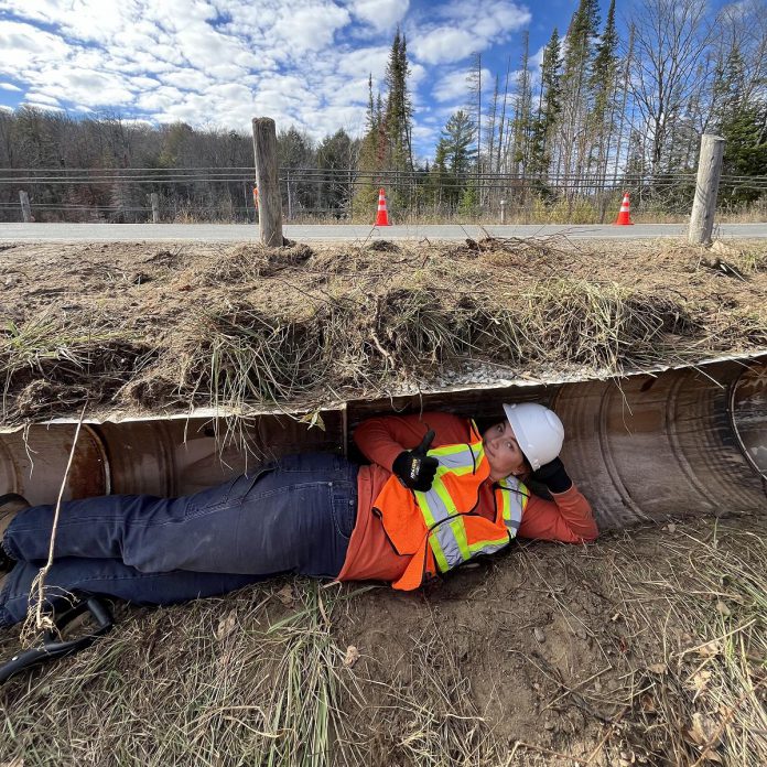 Addressing the limitations of traditional lateral fencing systems in ecopassages, Turtle Guardians designed and installed systems made from sections of steel barrels which are cost-efficient, durable, and require little maintenance. Backfilled and invisible from the road, the ecopassages direct turtles and other wildlife away from roadways and towards culverts that will get them to the other side. (Photo courtesy of The Land Between)