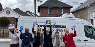 United Way Peterborough & District campaign officer Adeline Murphy, Kawartha Food Share warehouse coordinator Sunday Abdodunrin, Kawartha Food Share general manager Ashlee Aitken, United Way community impact officer Elisha Rubacha, United Way data/finance officer Joy Uson, and Peterborough & District Labour Council recording secretary Trish Bucholtz pose in front of the Kawartha Food Share van packed with menstrual hygiene products for those in need during the wrap-up event on March 16, 2026 for the 10th annual Period Promise campaign. (Photo courtesy of United Way Peterborough & District)