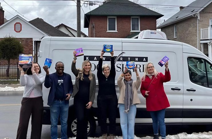 United Way Peterborough & District campaign officer Adeline Murphy, Kawartha Food Share warehouse coordinator Sunday Abdodunrin, Kawartha Food Share general manager Ashlee Aitken, United Way community impact officer Elisha Rubacha, United Way data/finance officer Joy Uson, and Peterborough & District Labour Council recording secretary Trish Bucholtz pose in front of the Kawartha Food Share van packed with menstrual hygiene products for those in need during the wrap-up event on March 16, 2026 for the 10th annual Period Promise campaign. (Photo courtesy of United Way Peterborough & District)