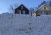 A windrow — the heavy ridge of snow pushed across the end of a driveway by passing plows — can be difficult to clear because it is densely packed and often mixed with ice and road treatment materials such as salt and sand, making it far heavier and harder to shovel, particularly for seniors and people with limited mobility. (Photo: Bruce Head / kawarthaNOW)