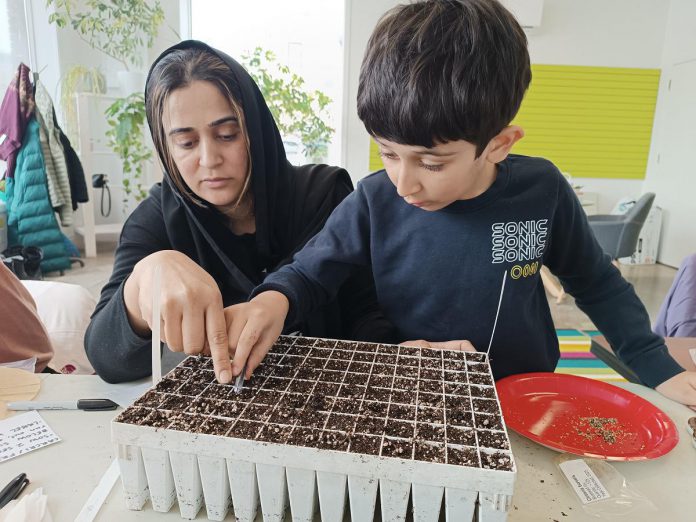 GreenUP volunteer Saima Sarfraz brings her son to propagate native plant species at a volunteer stewardship event. GreenUP's program areas are broad and include helping homes and businesses reduce energy consumption, creating habitat for native plants and wildlife, promoting active transportation habits, educating children and youth to instill a lifelong relationship with nature, planting trees, caring for community orchards, and so much more. (Photo: GreenUP)