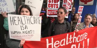 A protest in Toronto on April 14, 2026 against changes to the Interim Federal Health Program (IFHP) that would require refugees to begin paying fees for some healthcare services starting May 1. (kawarthaNOW screenshot of CBC video)