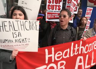 A protest in Toronto on April 14, 2026 against changes to the Interim Federal Health Program (IFHP) that would require refugees to begin paying fees for some healthcare services starting May 1. (kawarthaNOW screenshot of CBC video)