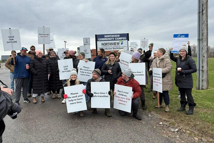 Parents and supporters at the Northview Community Campus in Peterborough, home to Northview Community Church and the Northview Daycare and Nursery School (Northview DaySchool), during an awareness event on April 19, 2026 with signs urging the church's board to reconsider the July 31 eviction deadline for Northview DaySchool and grant an extension until next February. (Photo courtesy of Tyler George / Northview DaySchool Parents)