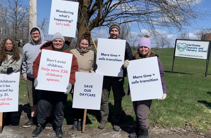 Parents and supporters at the Northview Community Campus in Peterborough, home to Northview Community Church and the Northview Daycare and Nursery School (Northview DaySchool), during an awareness event on April 19, 2026 with signs urging the church's board to reconsider the July 31 eviction deadline for Northview DaySchool and grant an extension. (Photo: Bethan Bates / kawarthaNOW)