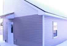 A "tiny home" built in the backyard of a residential property owned by One City Peterborough, part of a partnership with Peterborough Action for Tiny Homes (PATH) to construct additional rental units (ARUs) after PATH was unsuccessful in its efforts to obtain approvals from the City of Peterborough for temporary use by-laws to build a sleeping-cabin community for chronically unhoused people. (kawarthaNOW screenshot of One City Peterborough video)