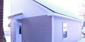 A "tiny home" built in the backyard of a residential property owned by One City Peterborough, part of a partnership with Peterborough Action for Tiny Homes (PATH) to construct additional rental units (ARUs) after PATH was unsuccessful in its efforts to obtain approvals from the City of Peterborough for temporary use by-laws to build a sleeping-cabin community for chronically unhoused people. (kawarthaNOW screenshot of One City Peterborough video)