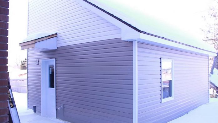 A "tiny home" built in the backyard of a residential property owned by One City Peterborough, part of a partnership with Peterborough Action for Tiny Homes (PATH) to construct additional rental units (ARUs) after PATH was unsuccessful in its efforts to obtain approvals from the City of Peterborough for temporary use by-laws to build a sleeping-cabin community for chronically unhoused people. (kawarthaNOW screenshot of One City Peterborough video)