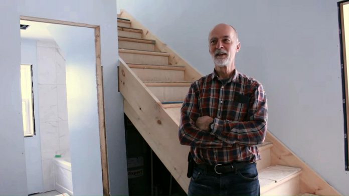 Peterborough Action for Tiny Homes board member Keith Dalton has been instrumental in the partnership with One City Peterborough to construct additional rental units (ARUs) to provide supportive housing options for tenants of residential properties owned by One City. (kawarthaNOW screenshot of One City Peterborough video)