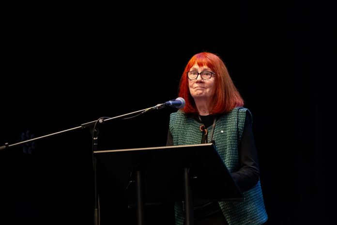  Lynn Zimmer, a founder of Canada's first crisis shelter for women fleeing domestic violence, the former long-time executive director of YWCA Peterborough Haliburton, and a member of the Order of Canada for her work and advocacy to prevent violence against women, speaks at the "A Conversation About The Status of Women In Our Community" event at Market Hall in downtown Peterborough on March 31, 2026, presented by Maryam Monsef's organization ONWARD in partnership with the Peterborough and Kawarthas Chamber of Commerce. (Photo: Jordan Lyall / kawarthaNOW)