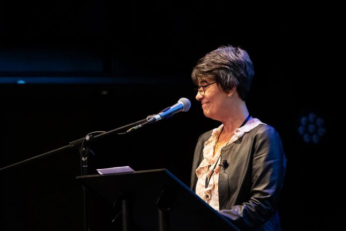 Retired teacher Cathy Ferreri speaks at the "A Conversation About The Status of Women In Our Community" event at Market Hall in downtown Peterborough on March 31, 2026, presented by Maryam Monsef's organization ONWARD in partnership with the Peterborough and Kawarthas Chamber of Commerce. (Photo: Jordan Lyall / kawarthaNOW)