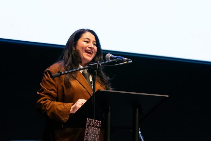 ONWARD founder and CEO Maryam Monsef speaks at the "A Conversation About The Status of Women In Our Community" event at Market Hall in downtown Peterborough on March 31, 2026, presented by ONWARD in partnership with the Peterborough and Kawarthas Chamber of Commerce. Monsef, who was Peterborough-Kawartha MP and a federal cabinet minister from 2015 to 2021 (including Minister for the Status of Women) prior to founding ONWARD, was also a close friend of the late Peterborough civic leader Ann Farquharson, who died unexpectedly in late 2025 and in whose honour the event was held. (Photo: Jordan Lyall / kawarthaNOW)