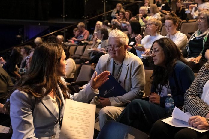 Peterborough MP Emma Harrison (left) chats with City of Peterborough Town Ward councillor Joy Lachica (middle) and Peterborough Downtown Business Improvement Area executive director Nour Mazloum during the "A Conversation About The Status of Women In Our Community" event at Market Hall in downtown Peterborough on March 31, 2026. All three women were among the 16 speakers at the event, which was presented by Maryam Monsef's organization ONWARD in partnership with the Peterborough and Kawarthas Chamber of Commerce. (Photo: Jordan Lyall / kawarthaNOW)