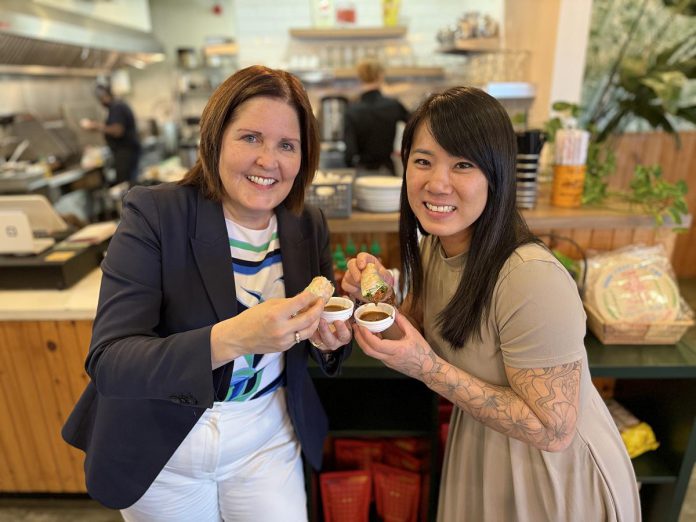 Peterborough Regional Health Centre (PRHC) Foundation President and CEO Lesley Heighway and Hanoi House owner Susan Tung enjoy a snack at Tung's Vietnamese restaurant on April 28, 2026 during the launch of the PRHC Foundation's new "Business Cares" program. To become a Business Cares partner, business owners choose how they want to give, whether it's by hosting a fundraiser, running a point-of-purchase promotion, becoming a sponsor, or making a direct contribution in a way that is meaningful to them. (Photo courtesy of PRHC Foundation)